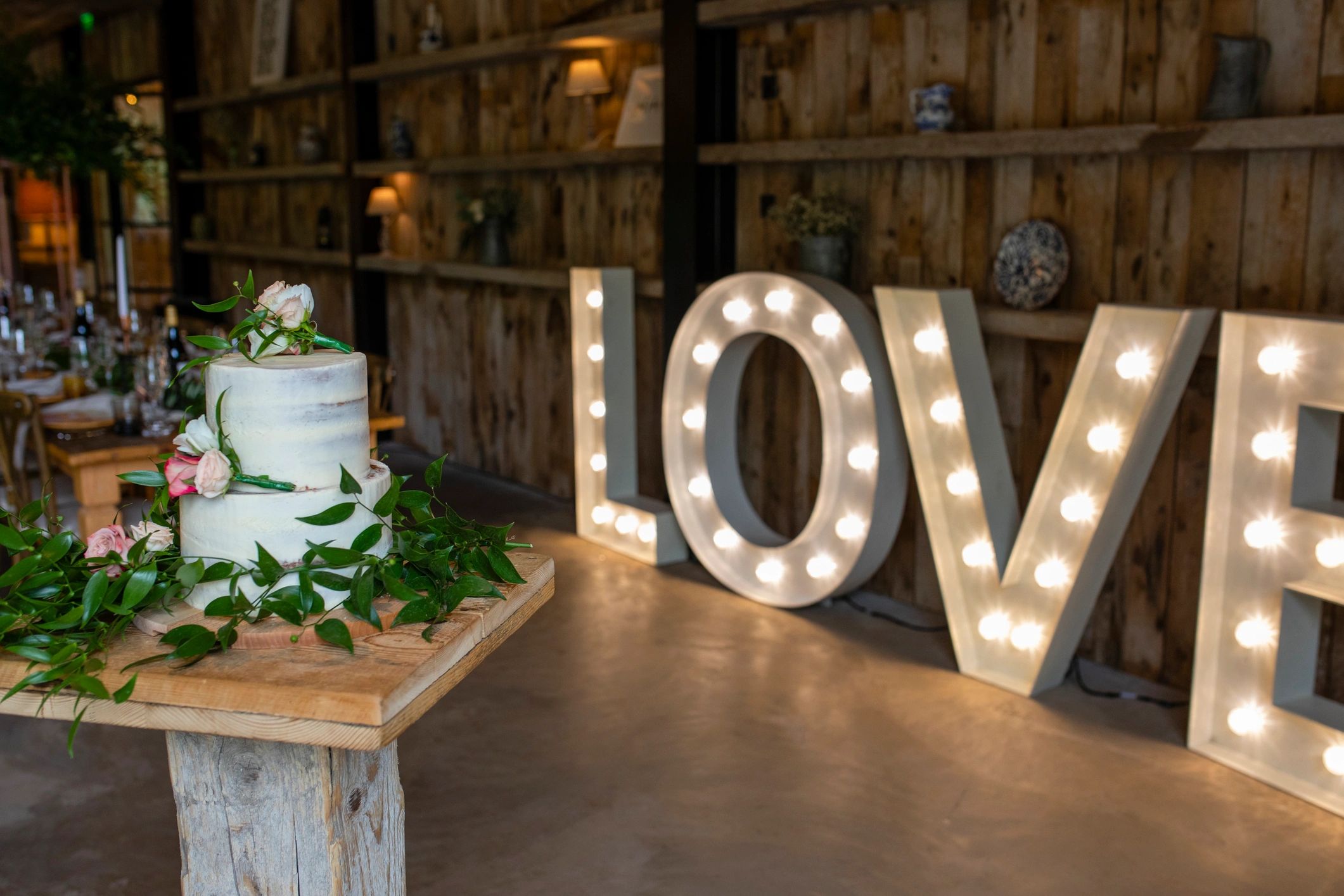 Decorated wedding cake with illuminated love letters