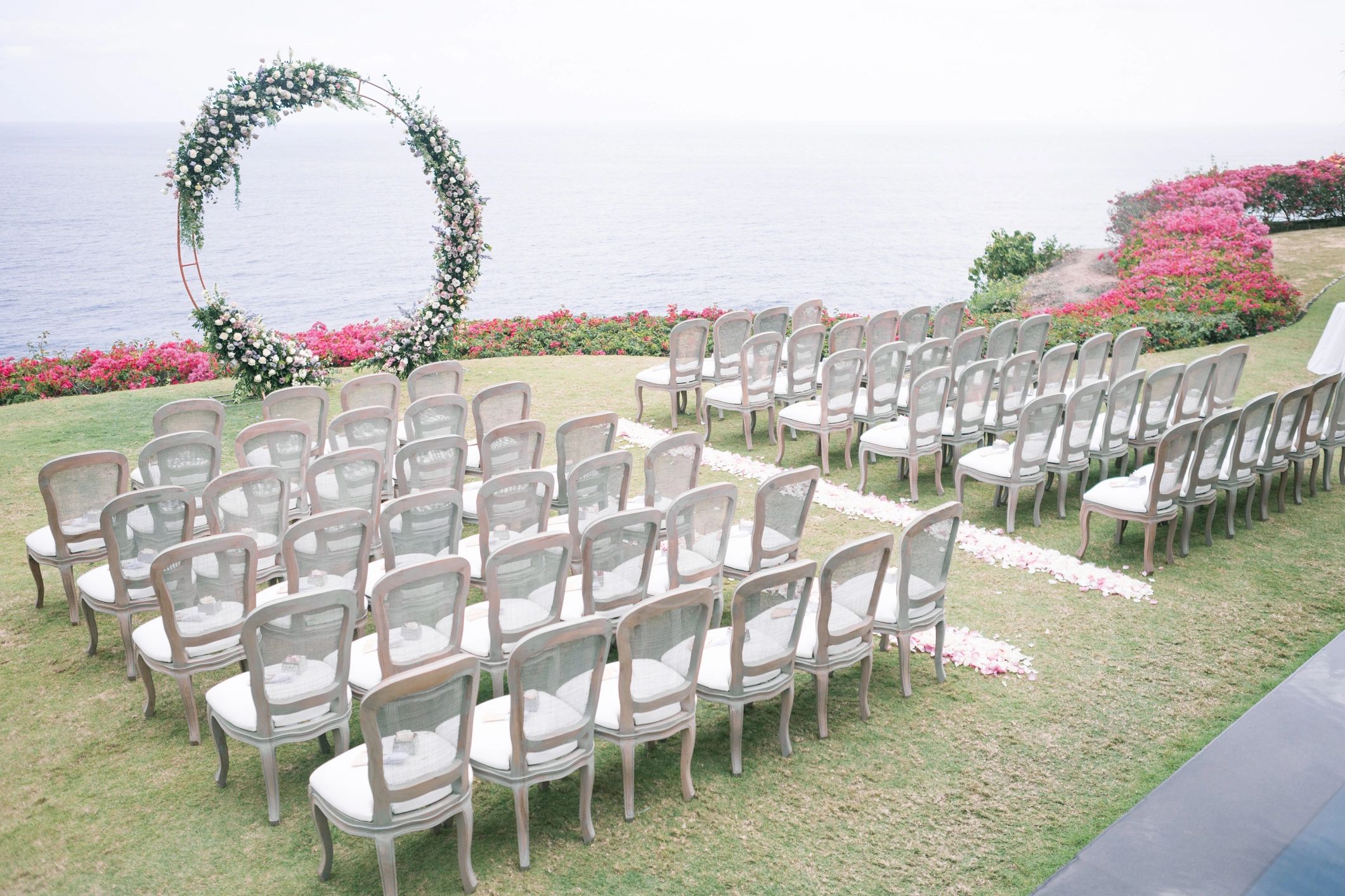 Ceremony arch with floral styling and guest seating
