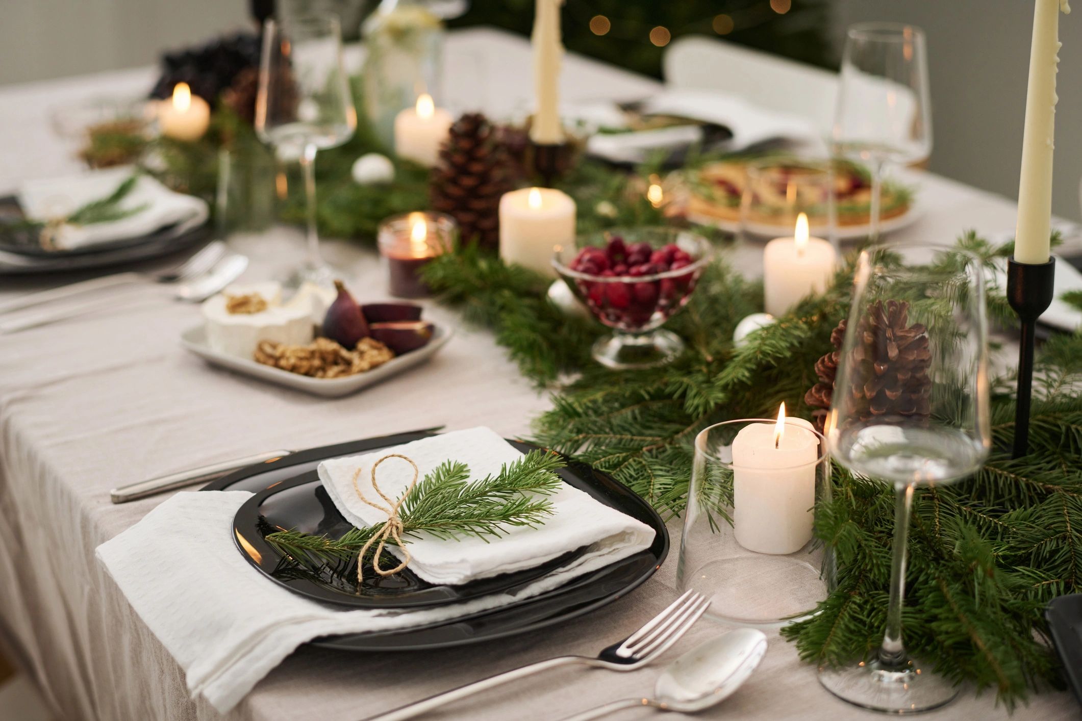 Festive place setting with seasonal greenery