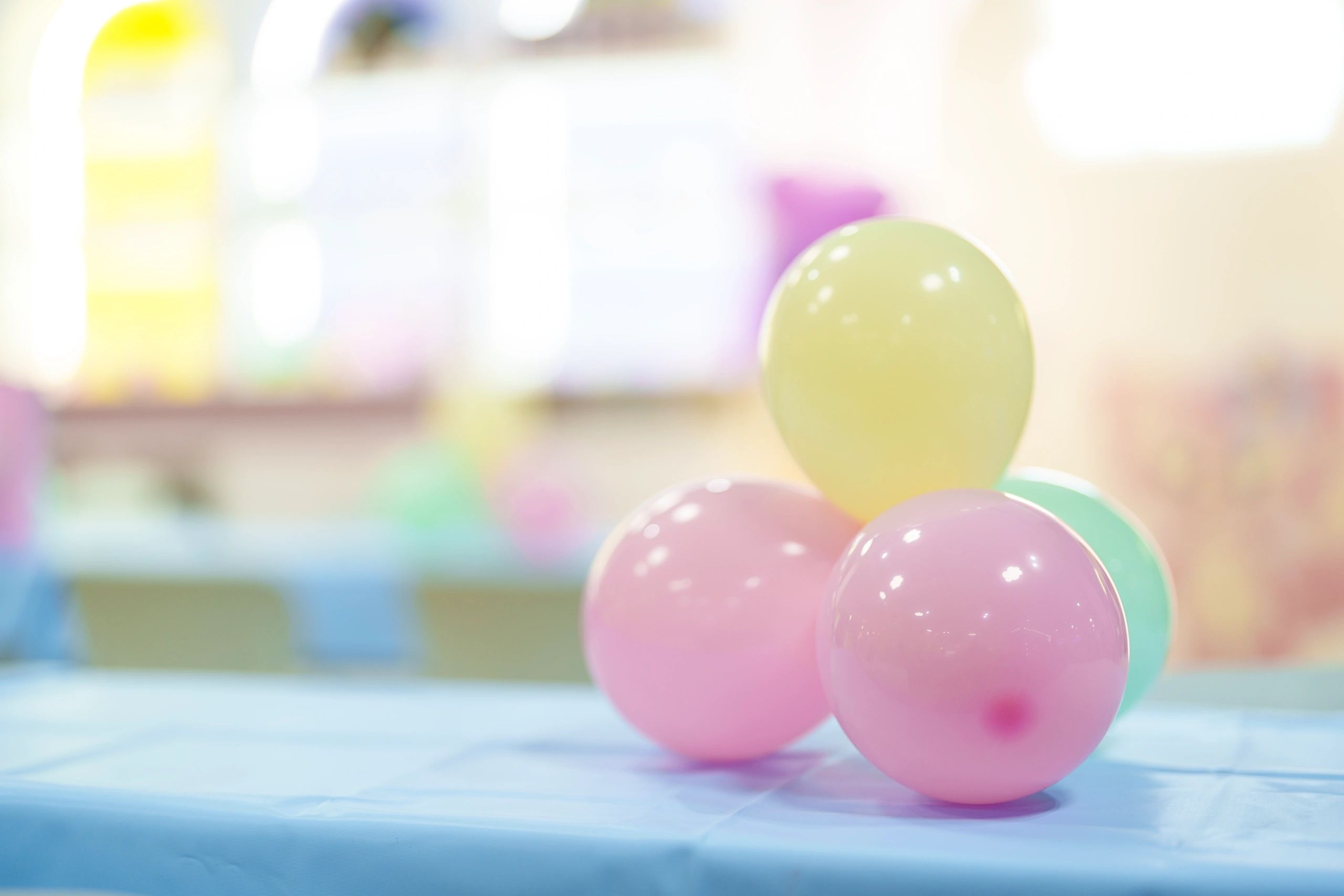Pastel balloon styling arranged on a decorated event table