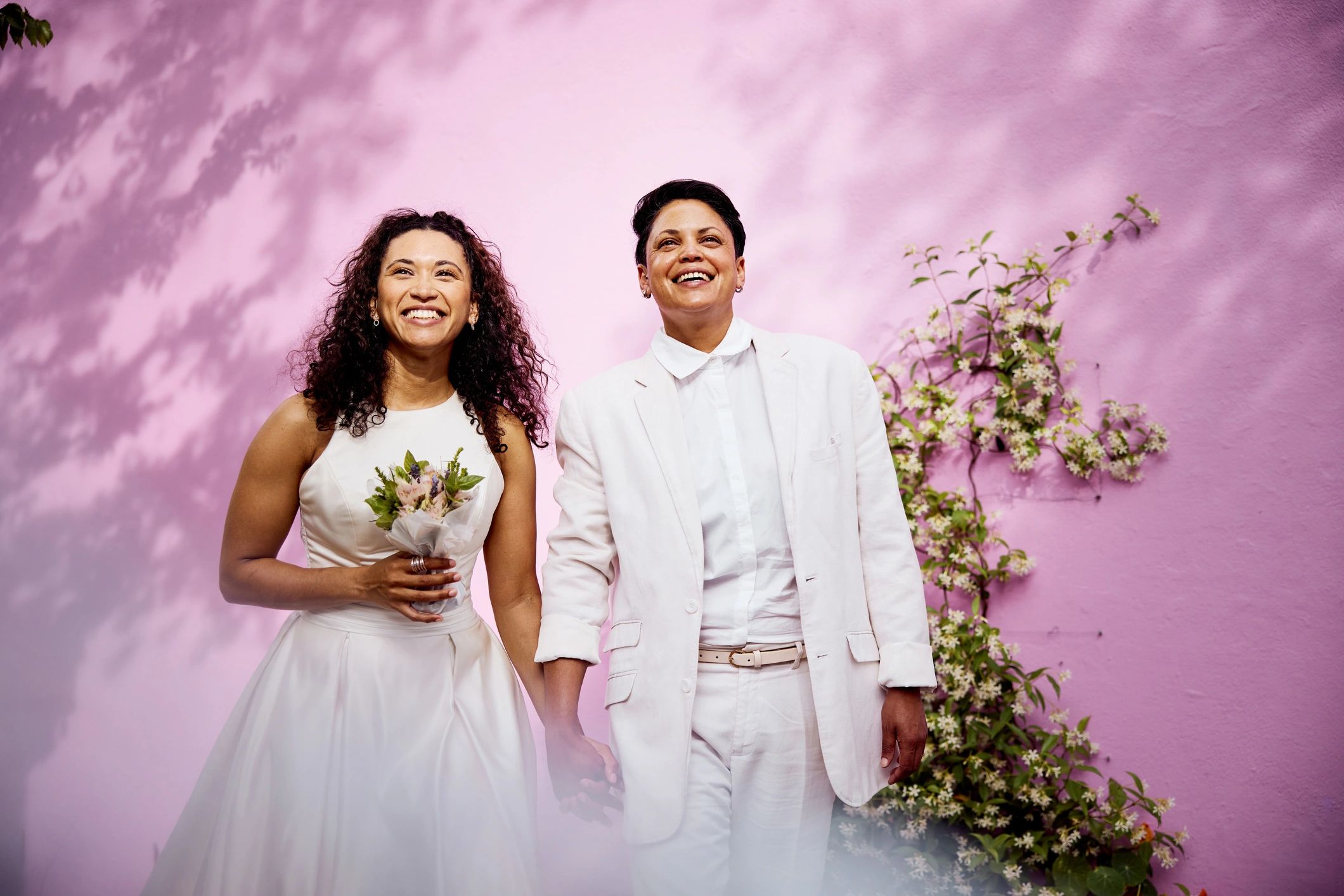 Christian wedding couple standing together in elegant formal attire with a refined editorial feel