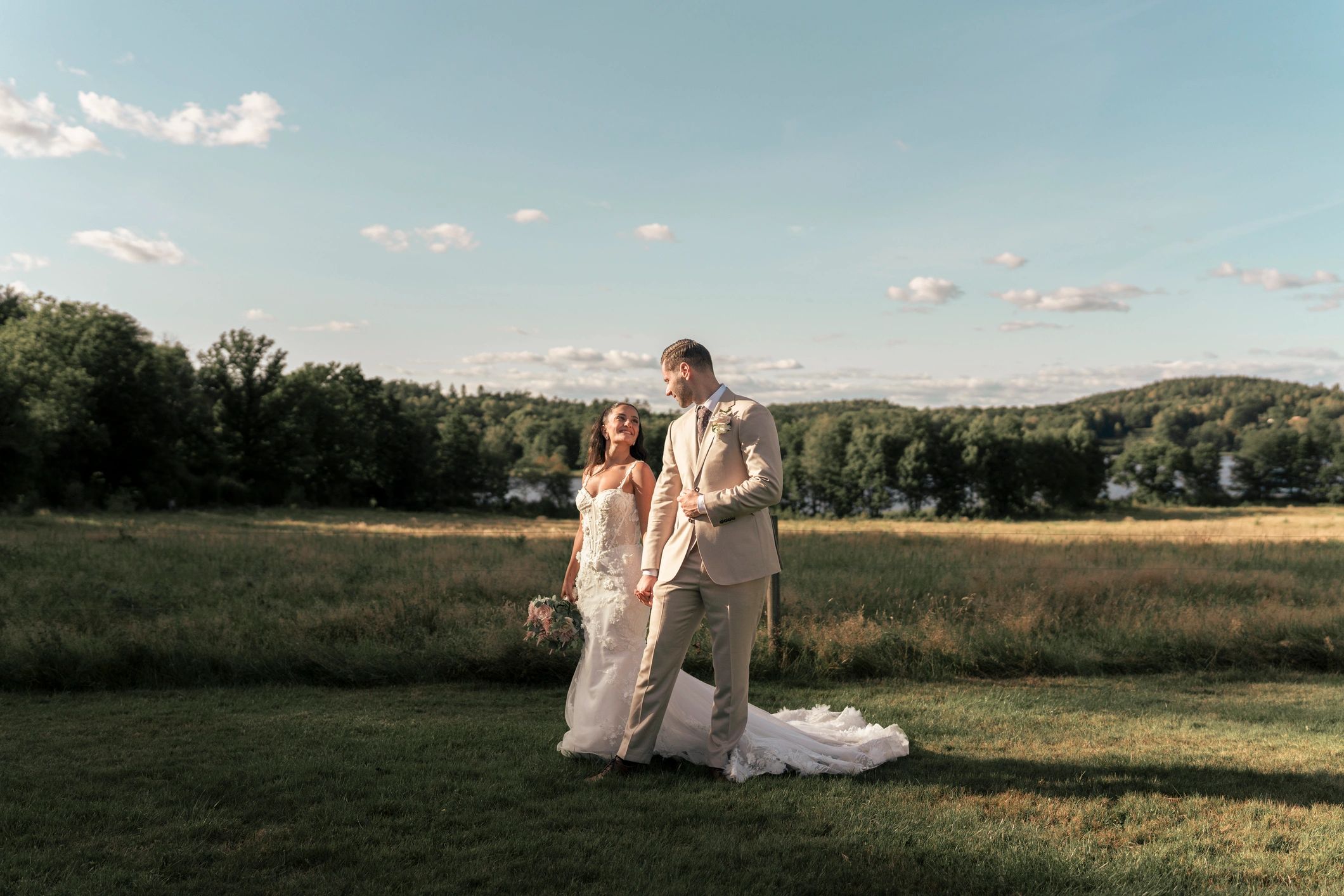 Bride and groom walking outdoors in a romantic setting